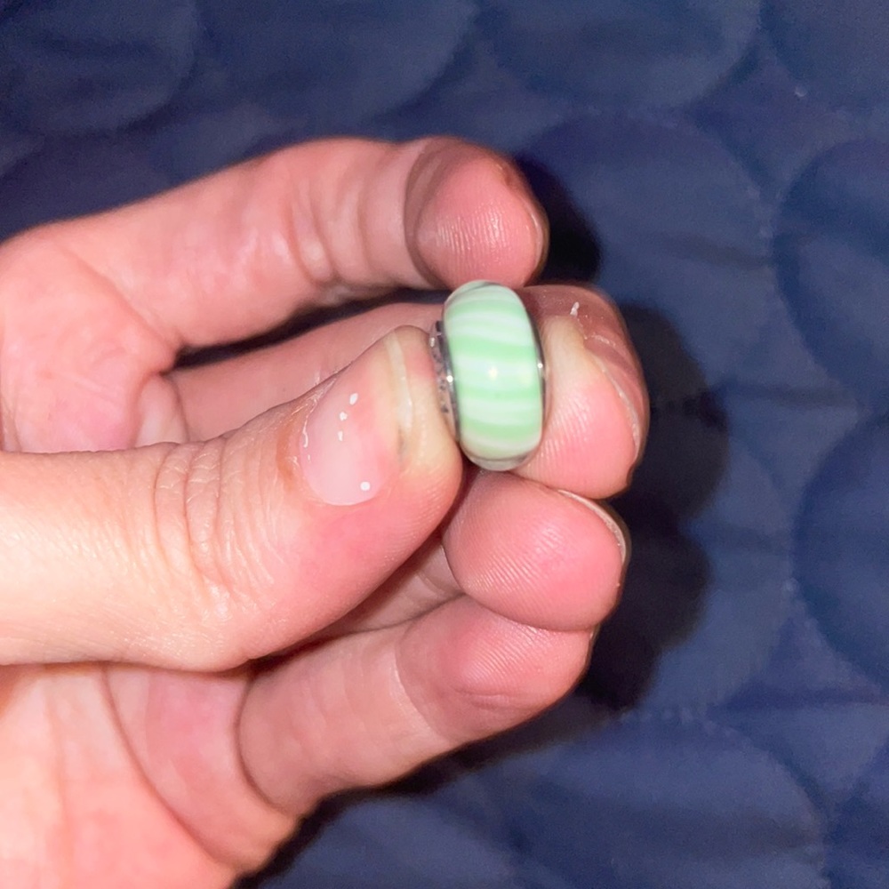 Green and white Pandora charm